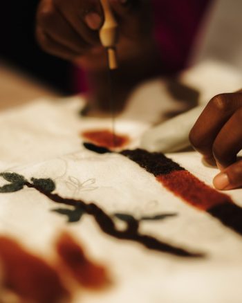 Needle felting a design in wool on cloth